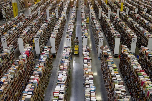 Employees collect merchandise ordered by customers for shipment from the Amazon.com distribution center in Phoenix, Arizona, U.S. on Monday, Nov. 26, 2012. U.S. retailers are extending deals into Cyber Monday and beyond to try to sustain a 13 percent gain in Thanksgiving weekend sales. Photographer: David Paul Morris/Bloomberg via Getty Images